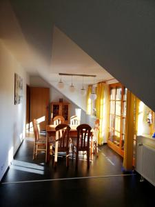 a dining room with a table and chairs at Harzwellness in Altenau