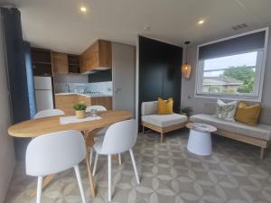 a kitchen and living room with a table and chairs at Ostseeferienpark Walkyrien - Bootsmann 10 in Schashagen +14 photos