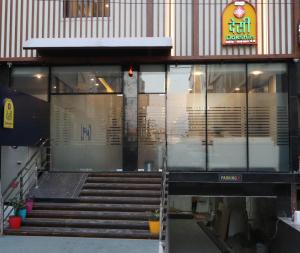a building with stairs in front of a building at Yellow Sapphire Hotel Gachibowli in Hyderabad