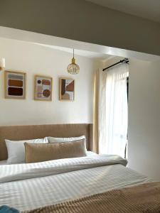 a bedroom with a large bed and a window at Coaral Bells Tsavo in Kiambu