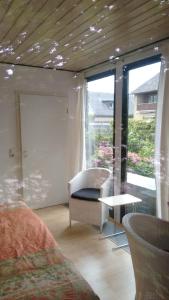 a bedroom with a bed and a table and a window at Ferienhaus Börstel mit Klimaanlage, Löhne in Löhne