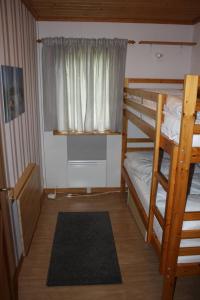 a bedroom with two bunk beds and a window at Ski-in/Ski-out | Sauna | Wi-Fi | Wood stove in Lofsdalen
