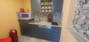 a small kitchen with a sink and a microwave at Ahornnest in Bingerbrück