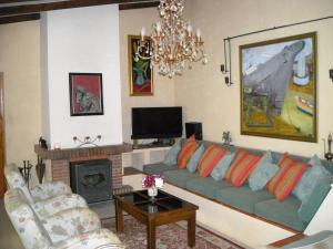 a living room with a couch and a fireplace at Finca La Ladera in Manilva