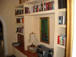 a room with a wall filled with books at Finca La Ladera in Manilva +25 photos