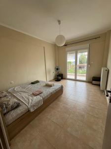 une chambre avec un lit et une grande fenêtre dans l'établissement Sunshine summer house, à Paralia Dionisiou