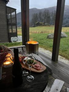 a table with a plate of food and a bottle of wine at Stylish apartment in Myrkdalen in Vossestrand