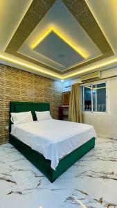 a bedroom with a large bed and a brick wall at fully renovated in a good location in Tangier