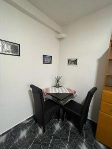 a table and two chairs in a room at Old City Home in Prizren