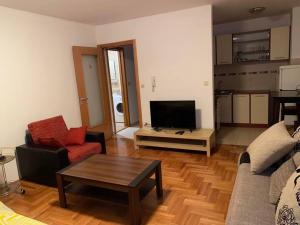 a living room with a couch and a coffee table at Filip apartment in Podgorica