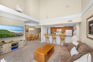a living room with a couch and a tv at Ocean State of Mind in Edisto Island