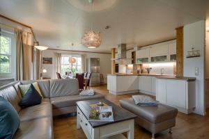a living room with a couch and a kitchen at Sandsturm in Prerow
