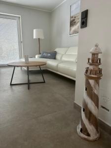 a living room with a couch and a table at Strandperle in Sankt Peter-Ording