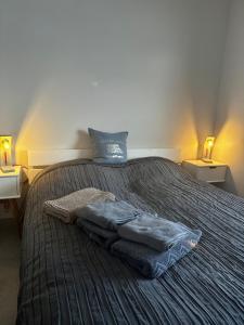 a bedroom with a bed with towels on it at Strandperle in Sankt Peter-Ording