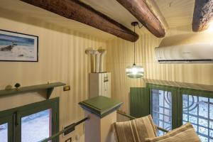 a room with a kitchen with a stove and windows at Antiba House in Ferrara