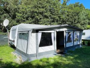 黑灵斯多夫Mietwohnwagen 03的草原上的白色帐篷