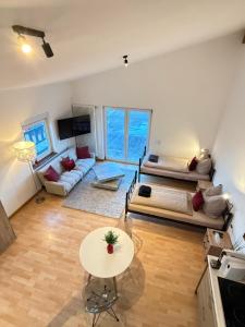 a living room with a bed and a table at Penthousewohnung Leingarten mit atemberaubendem Ausblick in Leingarten