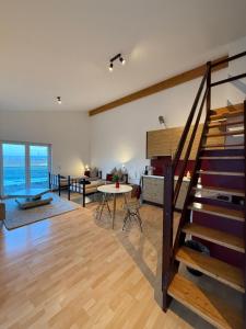 a living room with a staircase and a living room at Penthousewohnung Leingarten mit atemberaubendem Ausblick in Leingarten