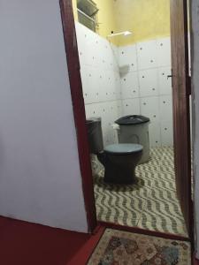 a bathroom with a toilet in a room at Casa Anahata in Algodoal +8 photos