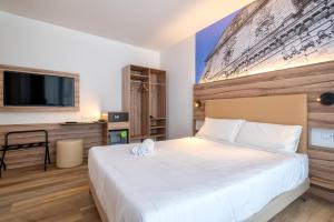Postel nebo postele na pokoji v ubytování B&B HOTEL Sassari