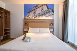 Postel nebo postele na pokoji v ubytování B&B HOTEL Sassari