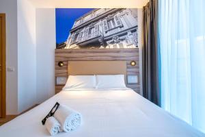 Postel nebo postele na pokoji v ubytování B&B HOTEL Sassari