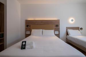 Postel nebo postele na pokoji v ubytování B&B HOTEL Sassari