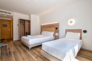 Postel nebo postele na pokoji v ubytování B&B HOTEL Sassari