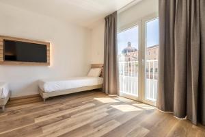 Postel nebo postele na pokoji v ubytování B&B HOTEL Sassari