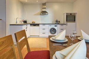 a kitchen with a table with chairs and a dining room at Thermen Appartements Gabriela, Appartement 75 qm in Bad Krozingen