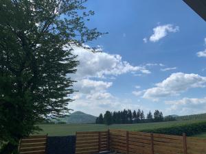 a wooden fence with a view of a field at Luxuriöses Ferienhaus in Luftkurort Lückendorf +17 photos