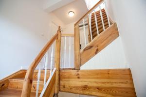 a staircase in a house with wooden rails at Apartment No5 in Stralsund