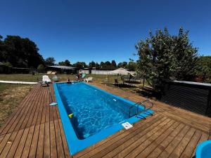 a large swimming pool on a wooden deck at Casa Grande en Osorno central en parcela 2 para 6 p in Osorno