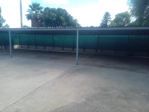 a large parking lot with a green building at Simekhona Guest House in Aangewysd