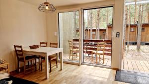 a living room with a table and chairs and a dining room at Fantastic in Doksy