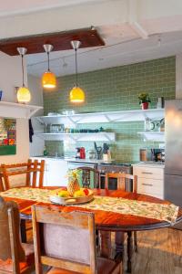 a kitchen with a table with a plate of fruit on it at Loerie's Perch - On Knysna Lagoon in Knysna