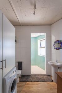 a bathroom with a shower and a toilet and a sink at Loerie's Perch - On Knysna Lagoon in Knysna