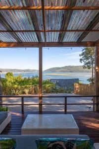 a living room with a view of the water at Loerie's Perch - On Knysna Lagoon in Knysna +15 photos