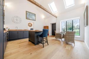 an open kitchen and dining room with a table and chairs at The Stable Barn, Smallwood Farm House in Hessett +15 photos