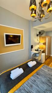 a bedroom with a bed with two white pillows at Piccolino Hyde Park Hotel in London