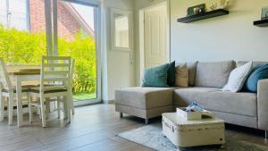 a living room with a couch and a table at Ostbake in Wangerooge