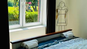 a bedroom with a window with a dress on the wall at Ostbake in Wangerooge