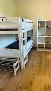 two bunk beds in a room with a wooden floor at Ostbake in Wangerooge +8 photos