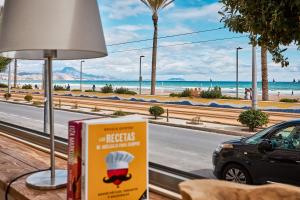 a sign with a chef on it next to a street at Conquistador A - by Welcomely in El Campello