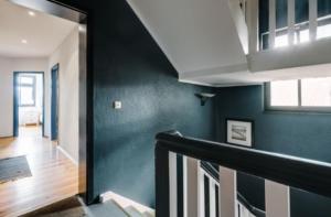a staircase in a house with a green wall at Studio 52 in Rankwitz