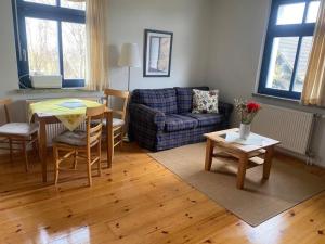 a living room with a couch and a table at Studio 52 in Rankwitz +1 photo