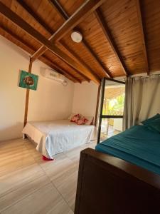 a bedroom with a bed and a tv in a room at Paradise BH in Maizal +21 photos