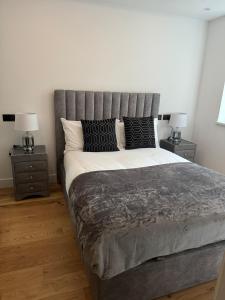 a bedroom with a large bed with two night stands at Knatchbull Cottage in Downhead