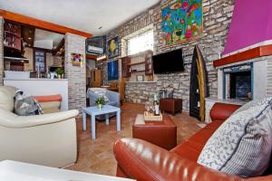 a living room with a couch and a fireplace at "Art House" Rovinj-Holiday in Rovinjsko Selo
