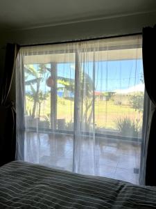 a bedroom with a window with a view of the ocean at Manu Kehu in Hanga Roa